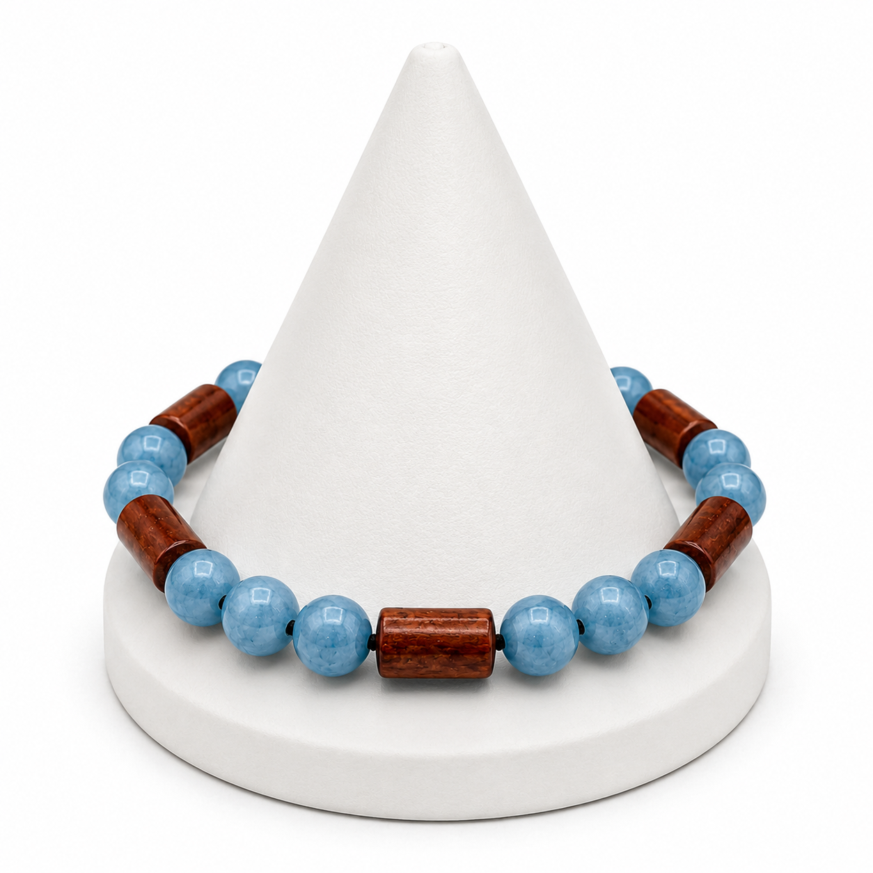 Bracelet with blue beads and wooden accents on a white cone-shaped stand