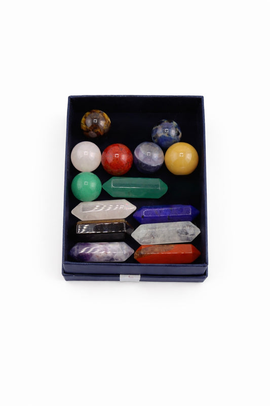 Set of chakra crystals in a box on a white background