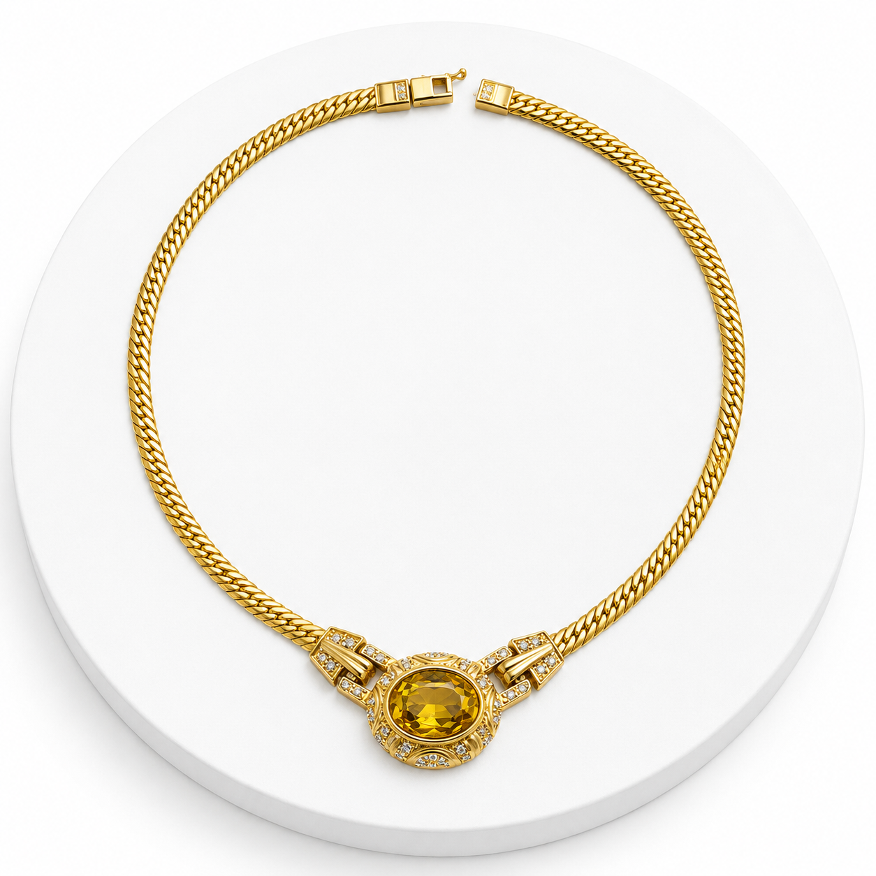 Gold necklace with a yellow gemstone on a white background