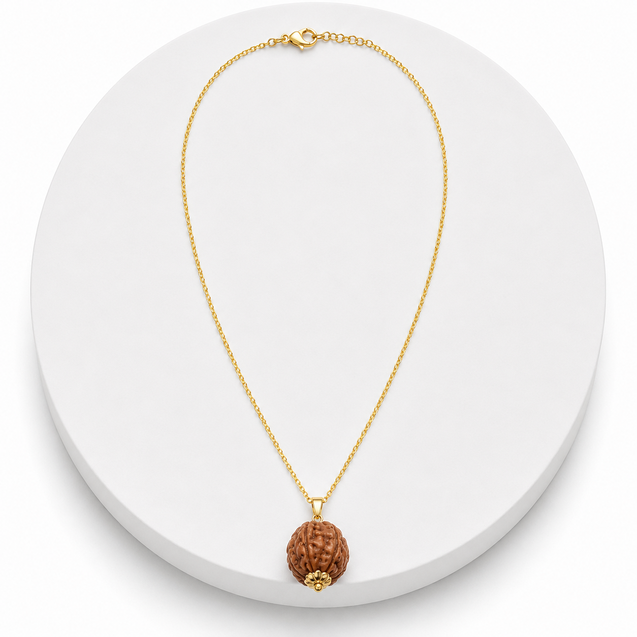 Gold necklace with a brown pendant on a white background