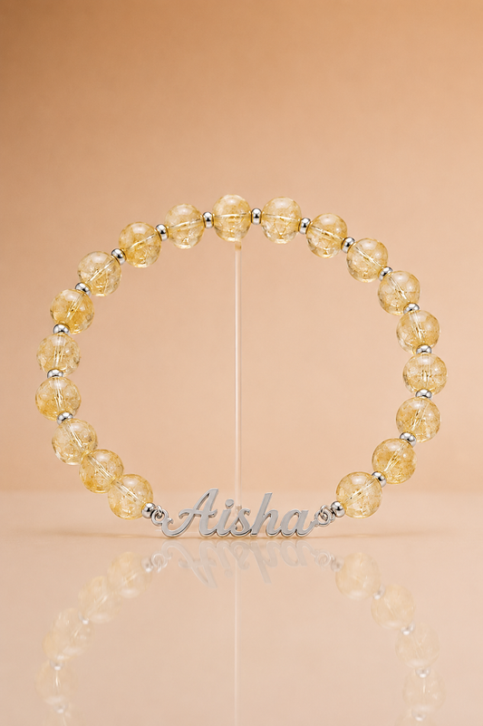Beaded bracelet with yellow beads and silver accents on a beige background