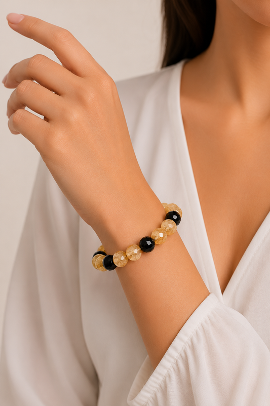 Woman wearing a beaded bracelet on a plain background
