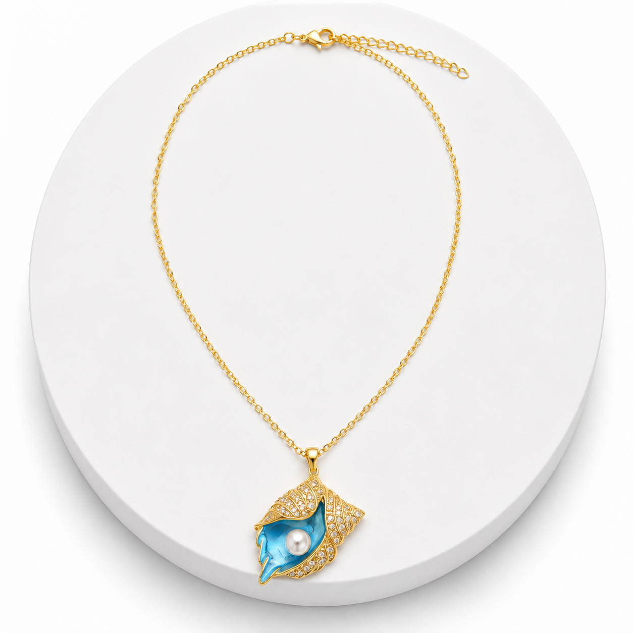 Gold necklace with a blue pendant featuring a pearl on a white background