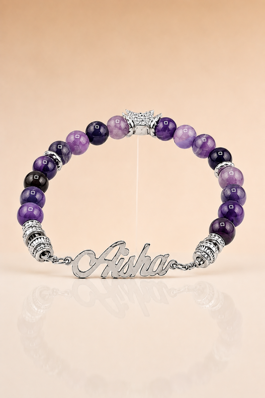 Purple beaded bracelet with silver clasp on a beige background
