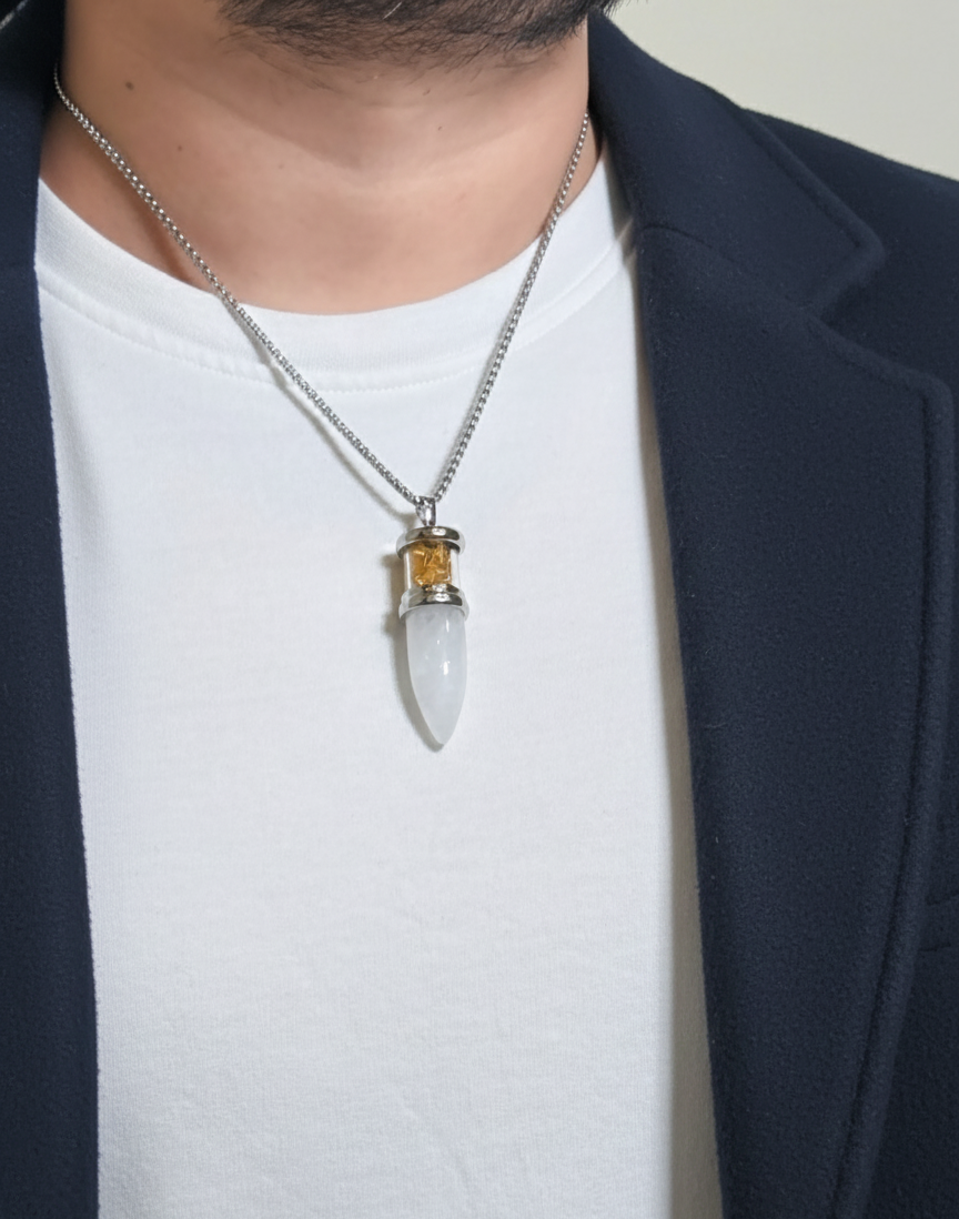 Necklace with a unique pendant worn by a person against a neutral background