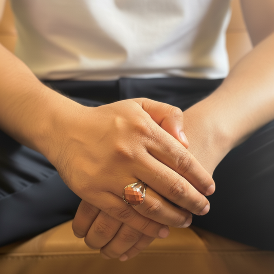 Close-up of hands clasped together on a wooden surface