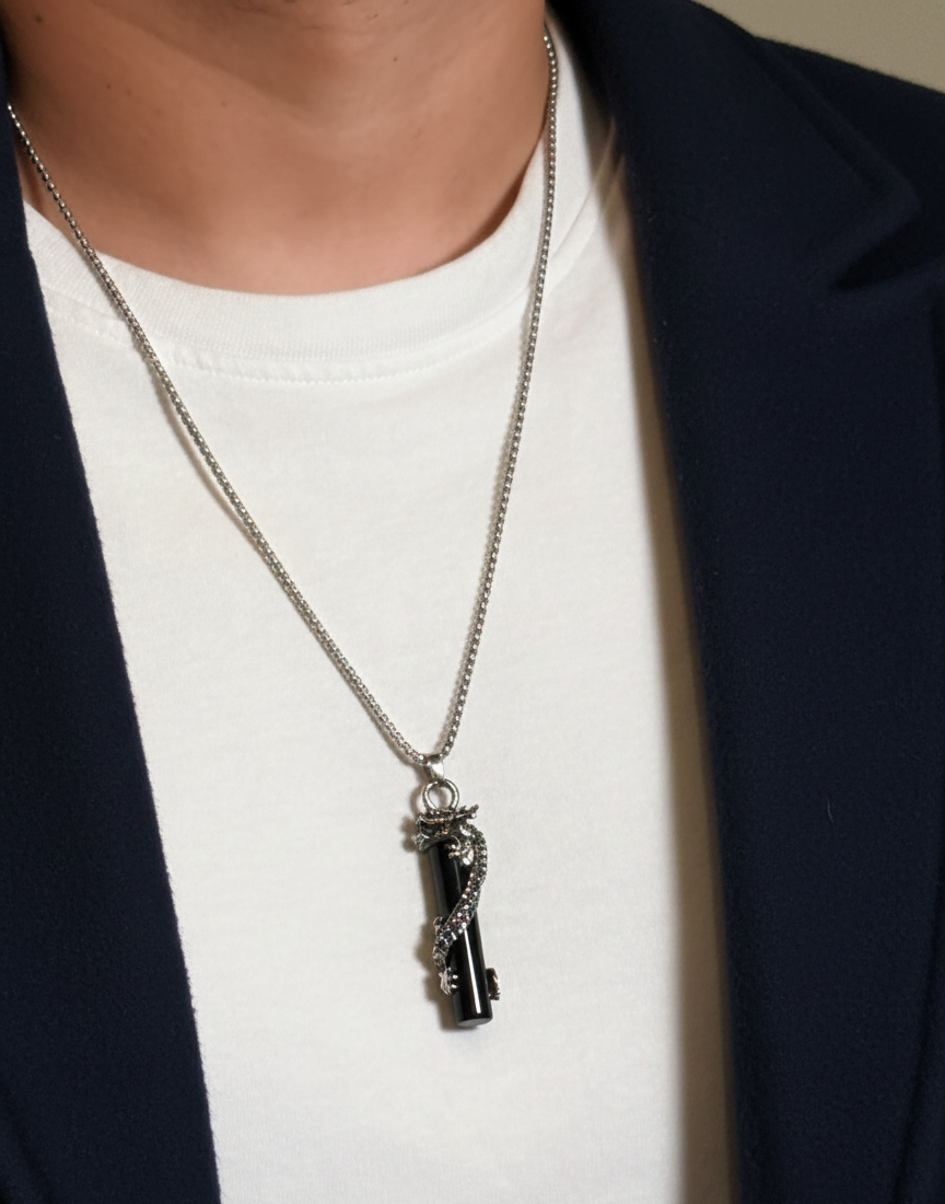 Necklace with a key pendant worn by a person against a neutral background