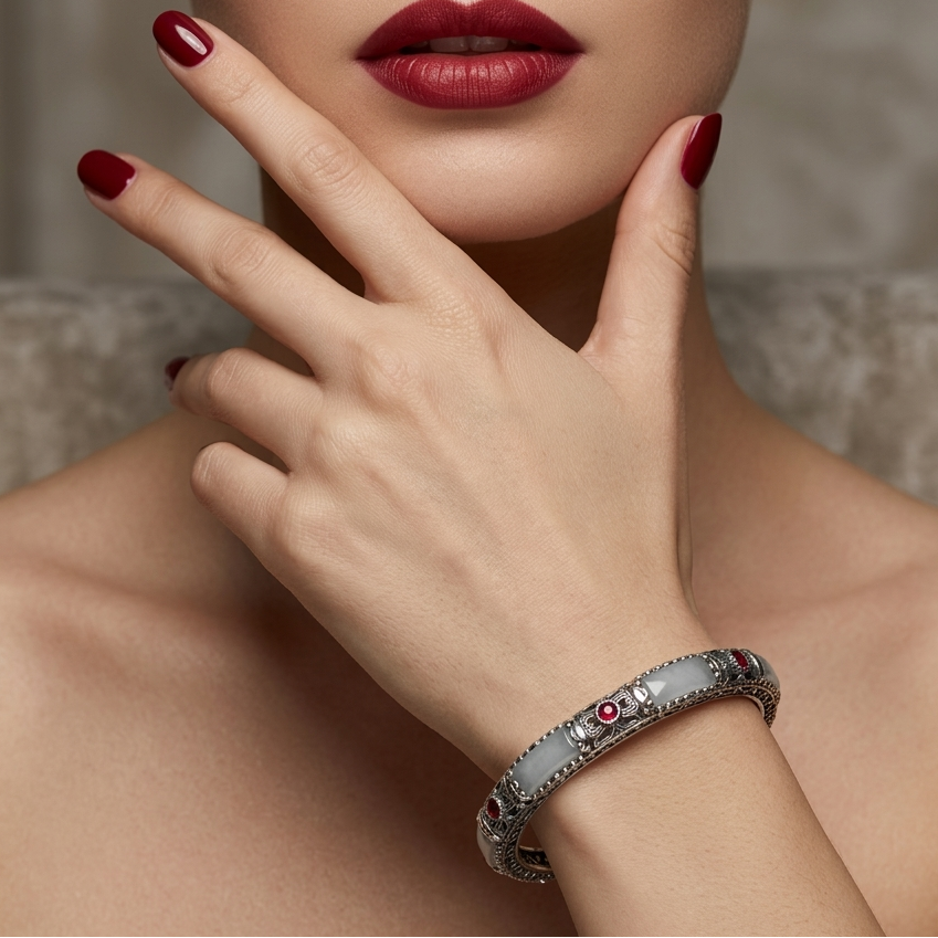 Close-up of a woman's hand wearing a bracelet with a neutral background