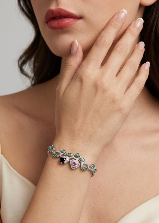 Close-up of a woman's hand wearing a decorative bracelet with gemstones on a neutral background