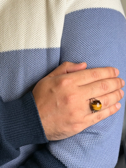 Close up of Tiger Eye stone ring on a man’s hand