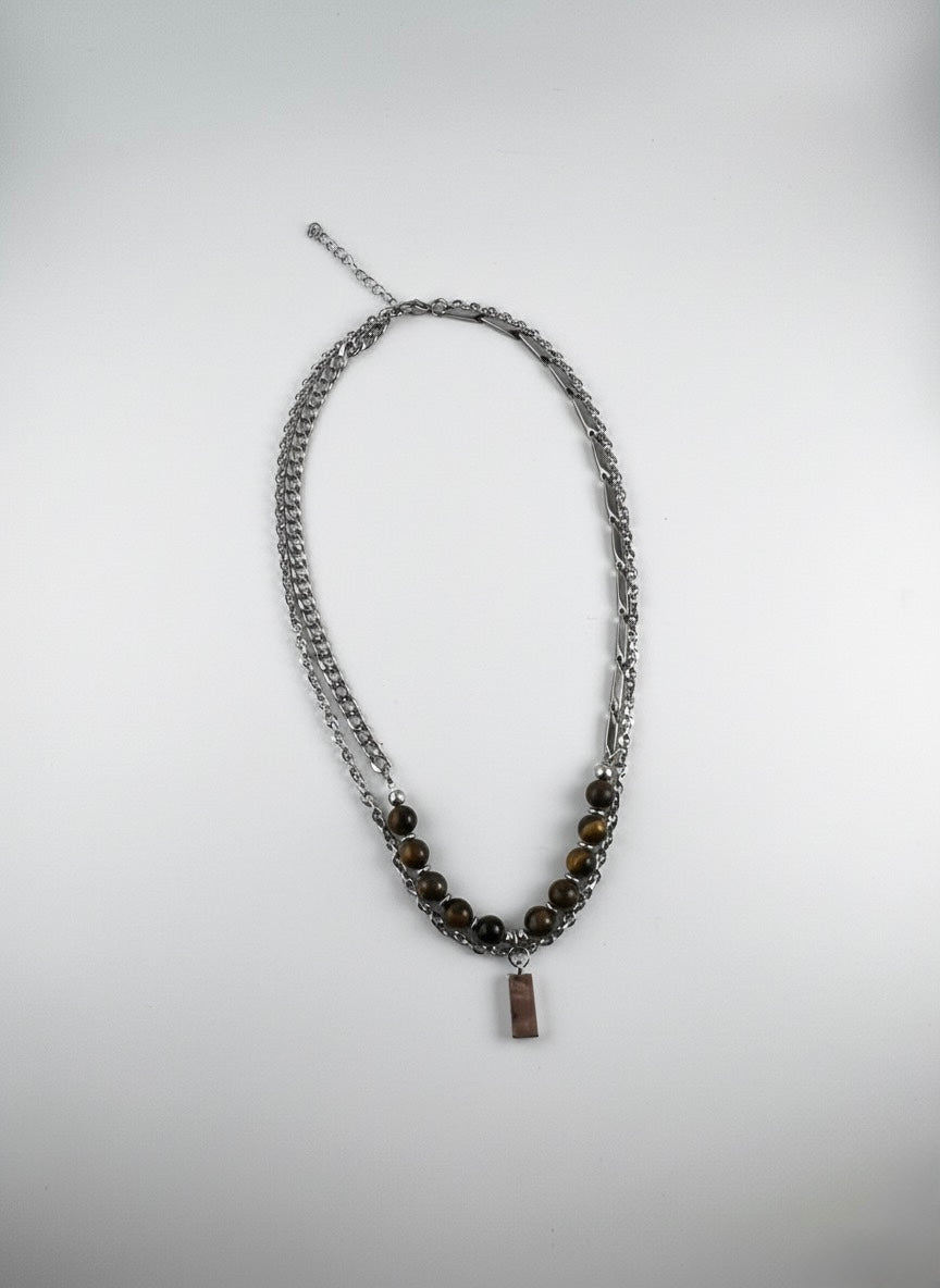 Tiger Eye pendant necklace styled on male chest for strength
