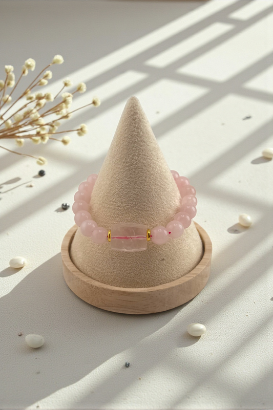 Pink beaded bracelet on a cone-shaped display with dried flowers in the background