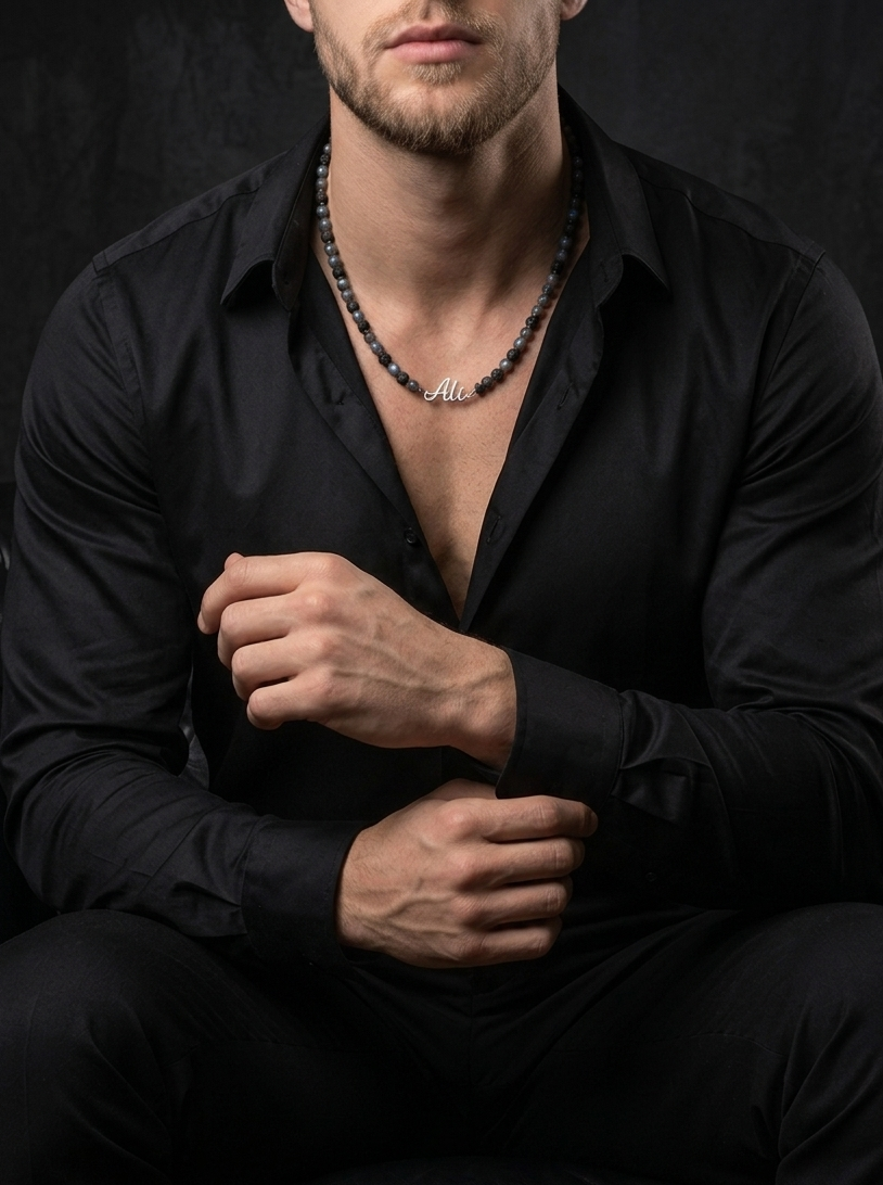 Man wearing a black shirt with a dark background