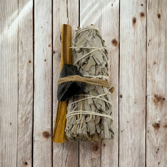 Bundled sage with a wooden tool on a wooden background