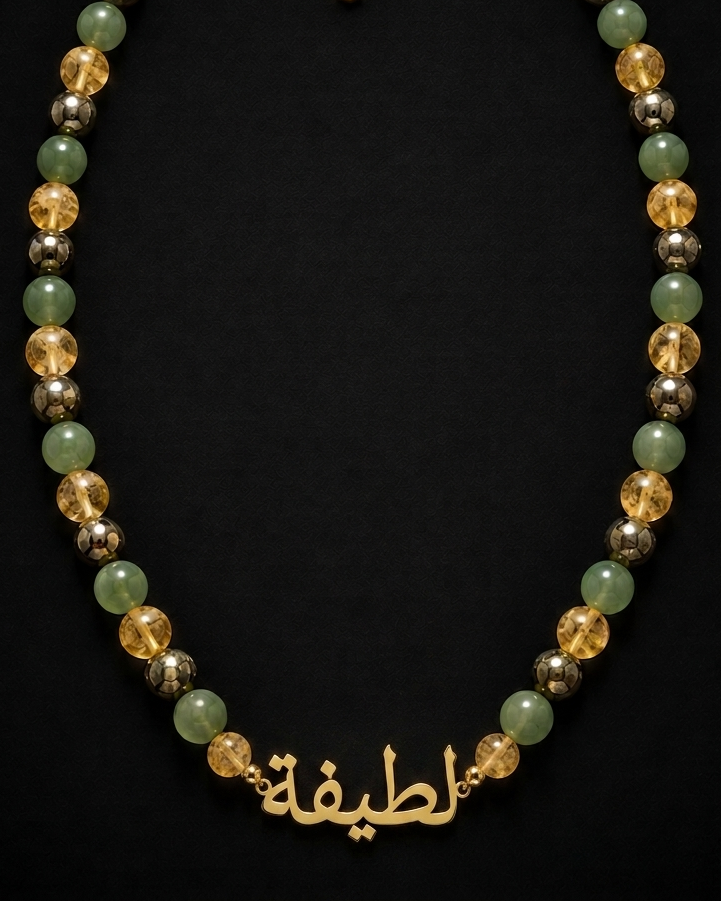 Necklace with multicolored beads and gold chain on a black background