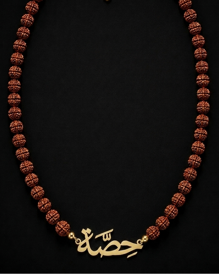 Necklace with brown beads and gold chain on a black background