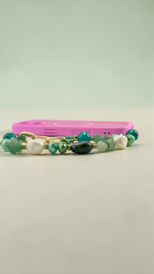 Two beaded bracelets with green and white beads on a light gray background