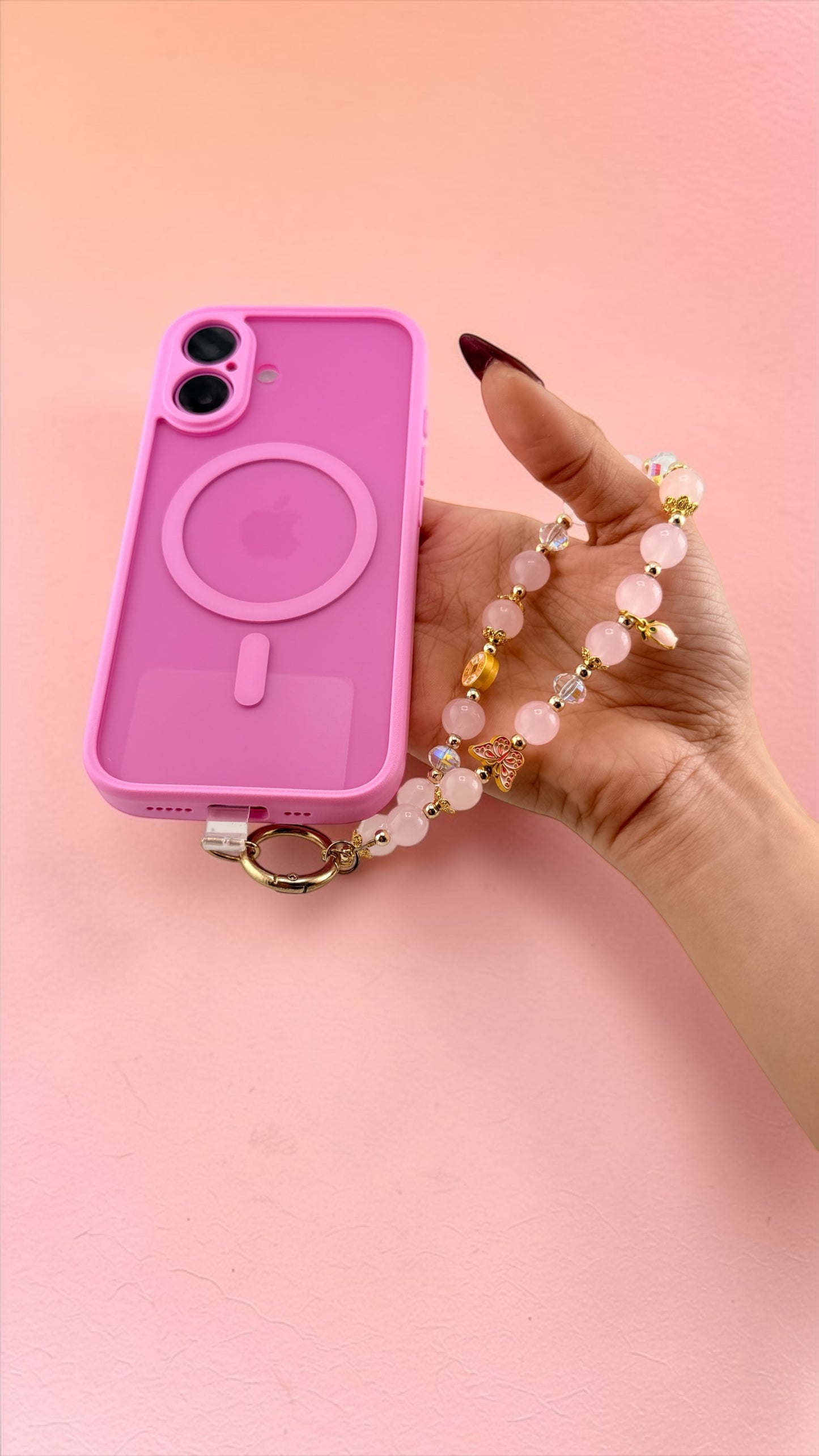 Pink phone case with a lanyard on a pink background