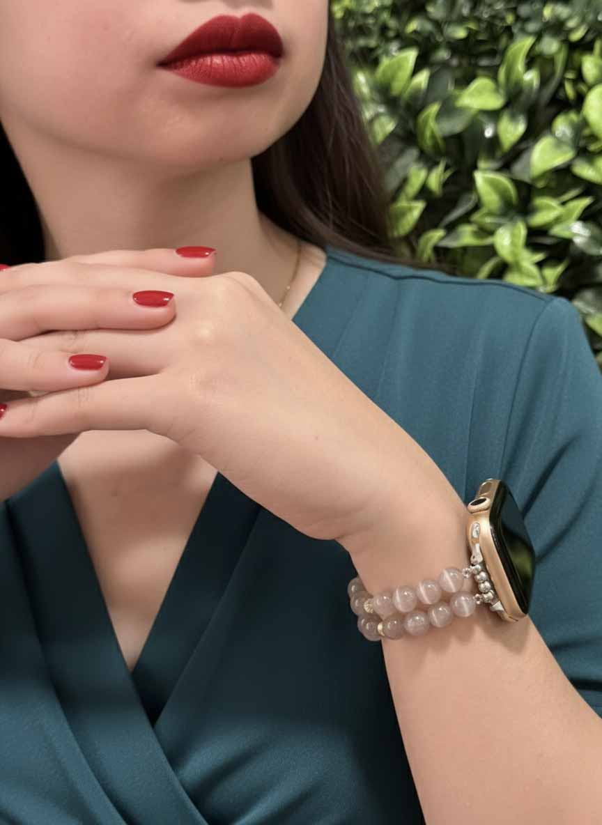 Woman wearing a bracelet with a green background