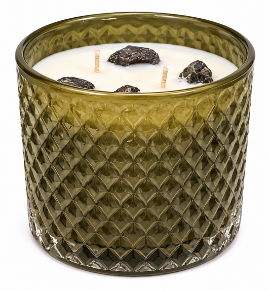 Green textured glass candle with visible wicks on a white background