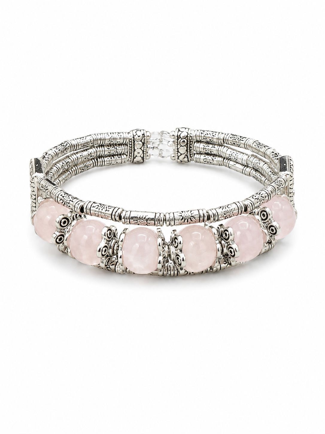 A multi-strand silver-toned bracelet featuring oval light pink gemstones and ornate filigree details, shown on a plain white background.