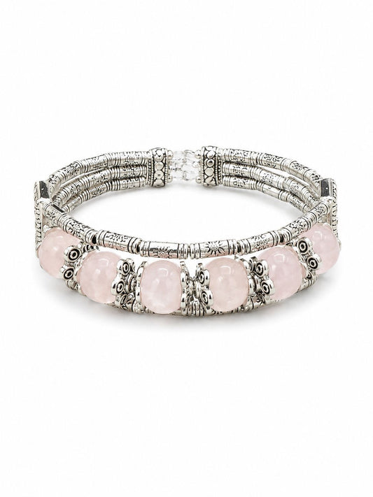A multi-strand silver-toned bracelet featuring oval light pink gemstones and ornate filigree details, shown on a plain white background.
