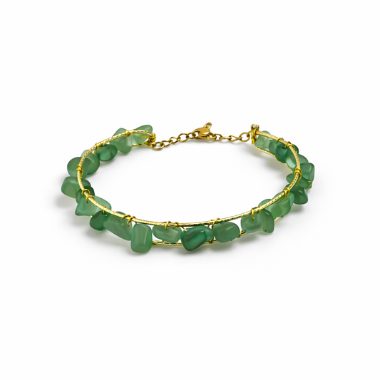 Green beaded bracelet with gold chain on a white background