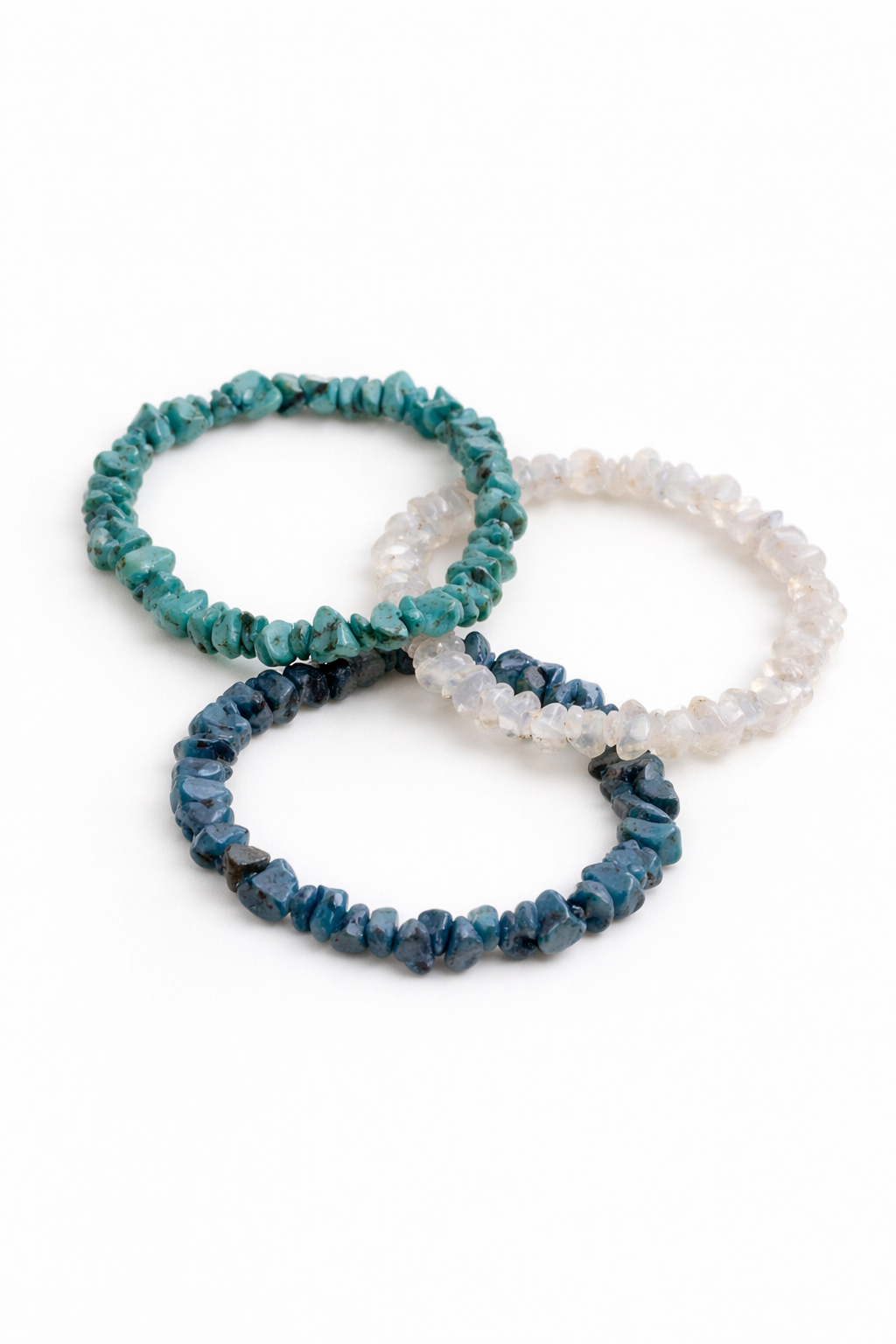 Three beaded bracelets in blue, green, and white on a white background