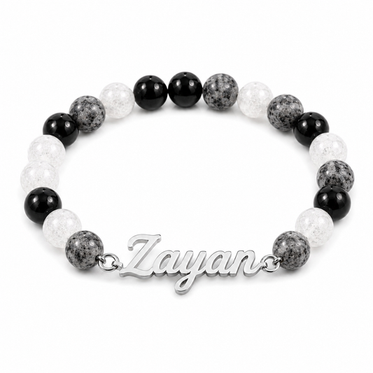 Bracelet with black, white, and gray beads and a silver 'Zayan' clasp on a white background
