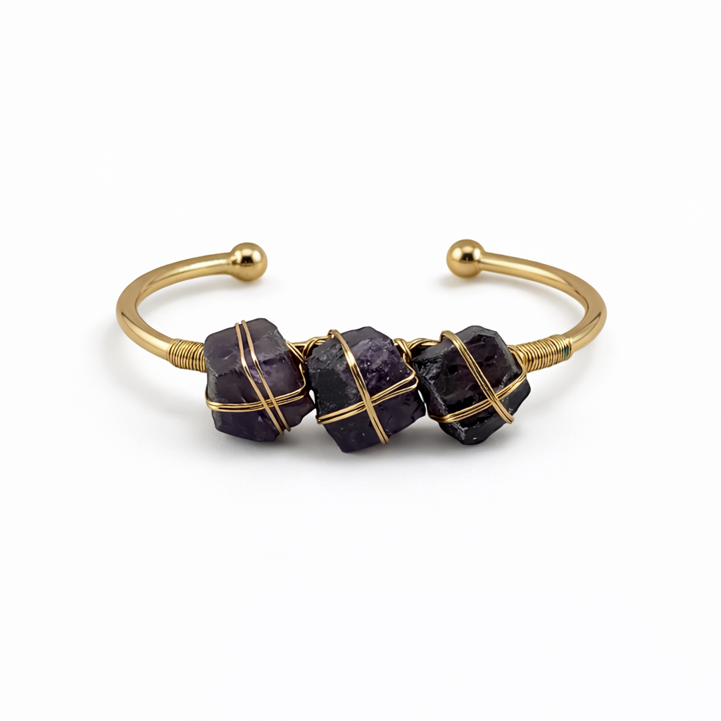 Gold bracelet with purple beads on a white background