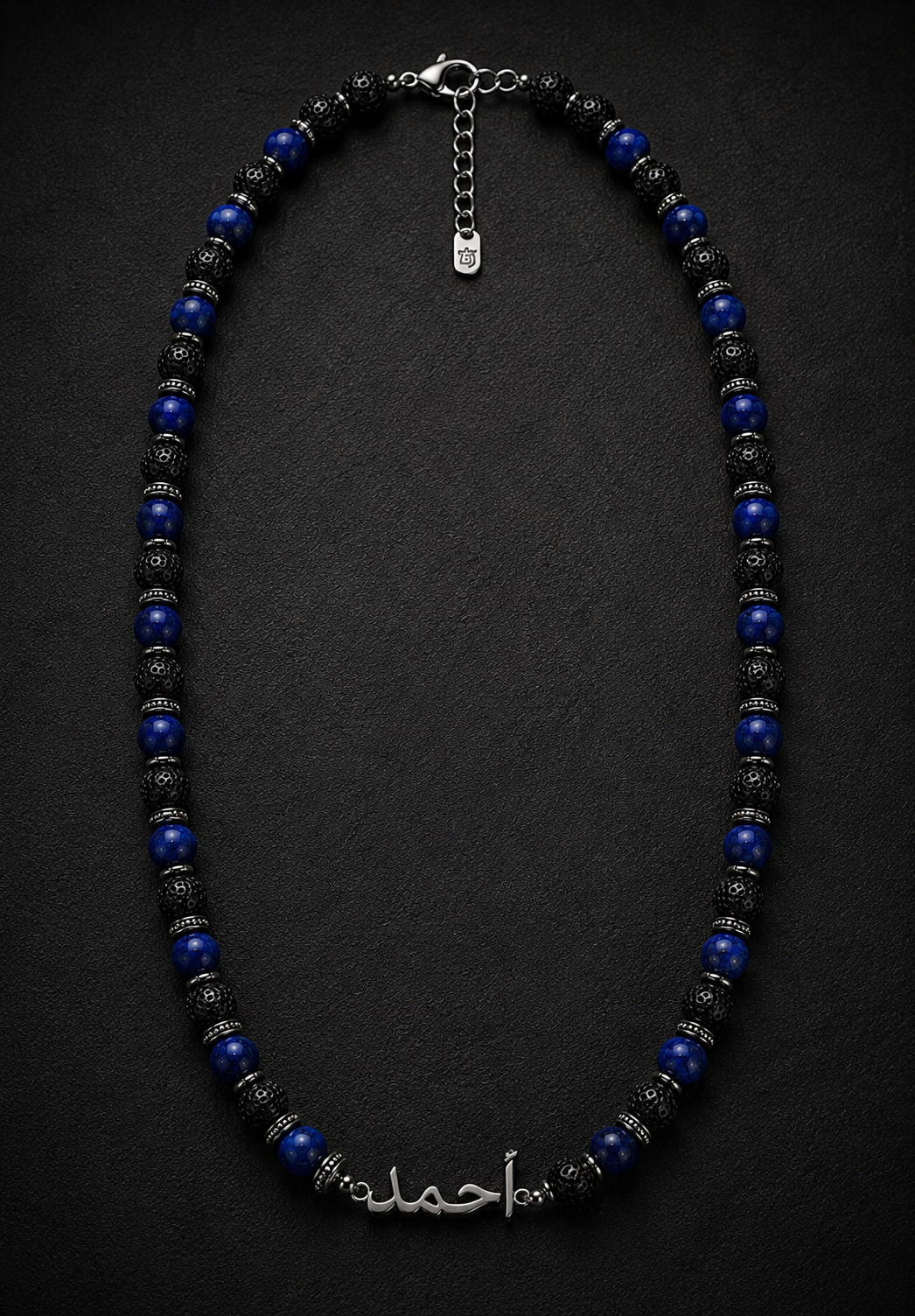 Necklace with blue and black beads on a dark background