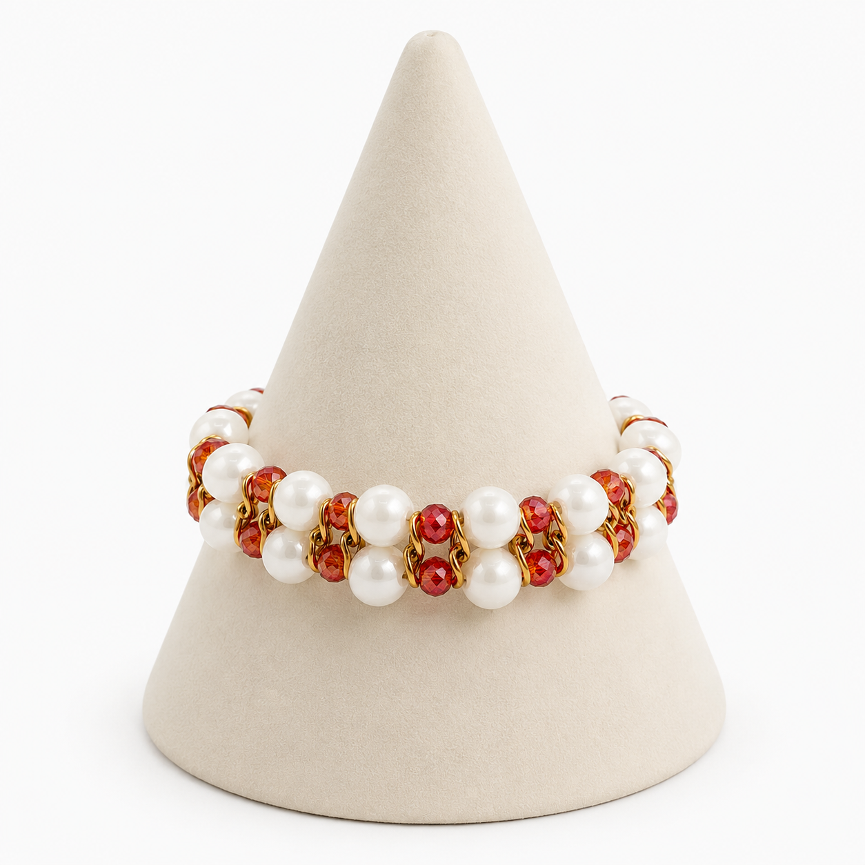 Bracelet with red and white beads on a beige cone-shaped stand against a white background