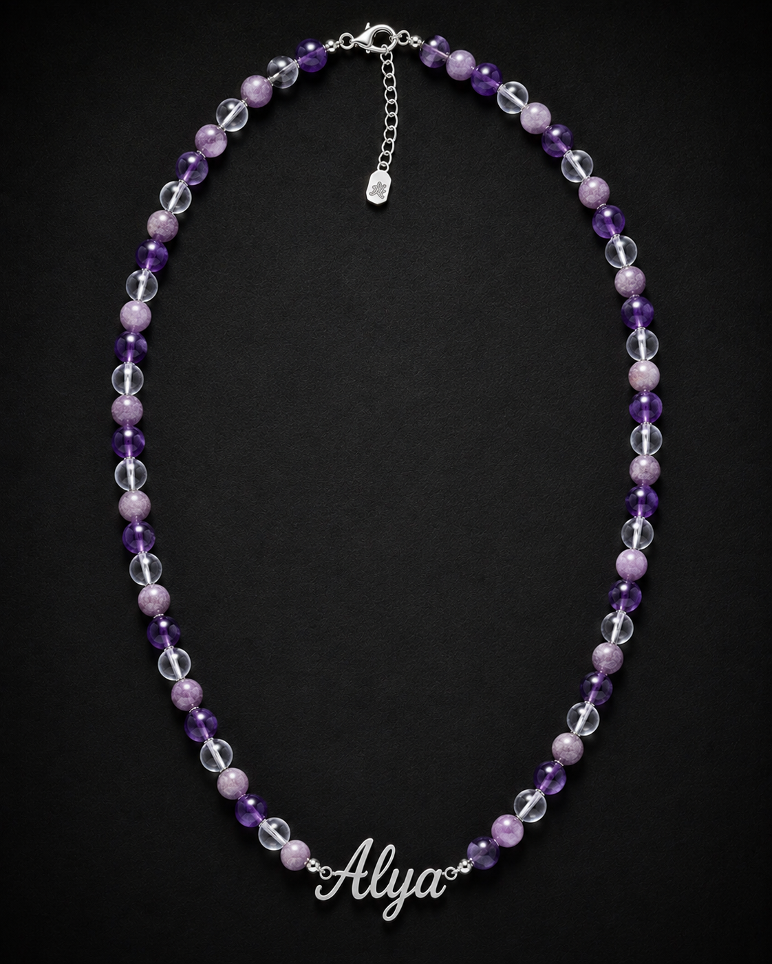 Necklace with purple and clear beads and a name charm on a black background