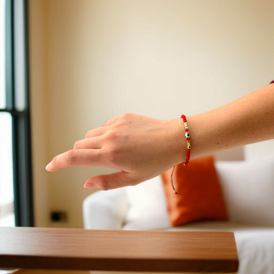 red protection bracelet with gold beads