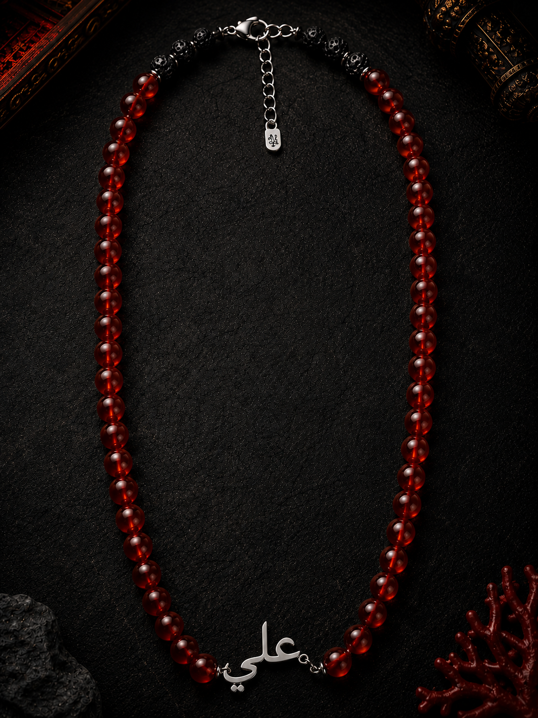 Red beaded necklace on a dark background