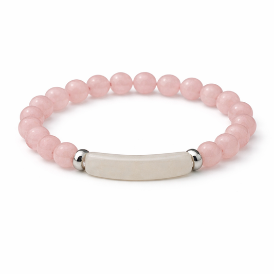 Pink beaded bracelet with a silver and beige bar clasp on a white background