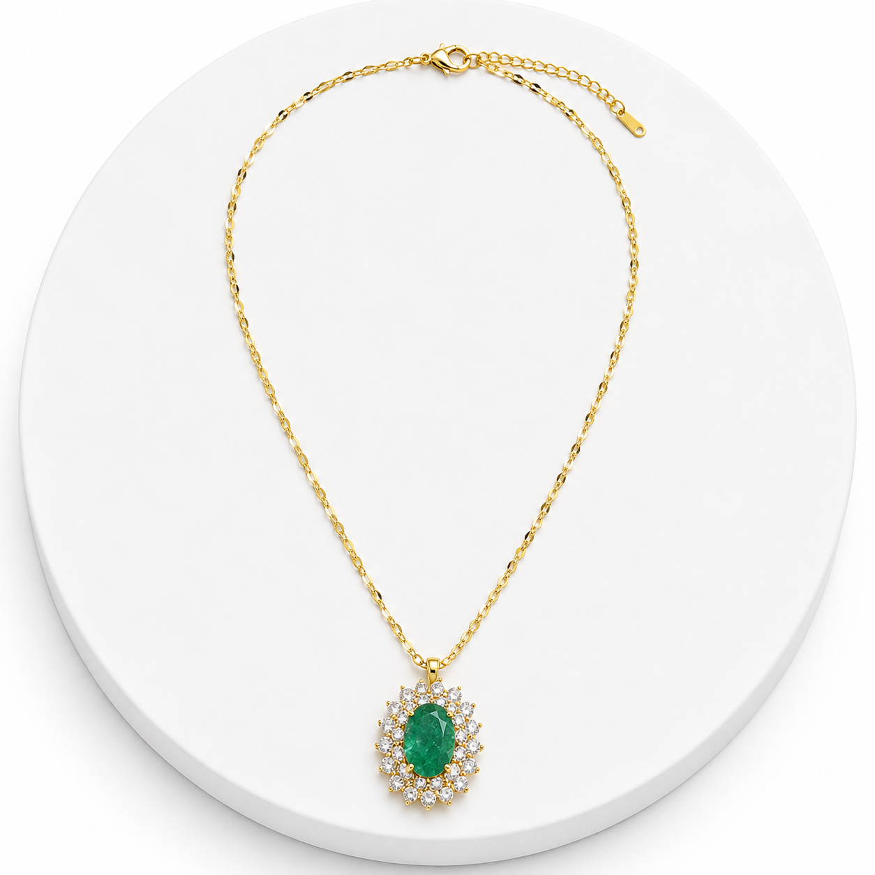Gold necklace with a green gemstone pendant on a white background