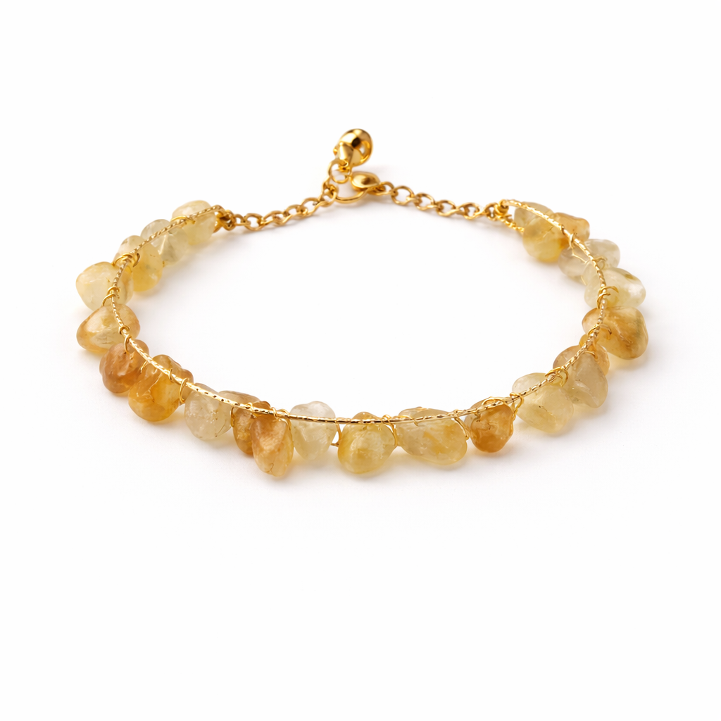 Gold bracelet with natural stone beads on a white background