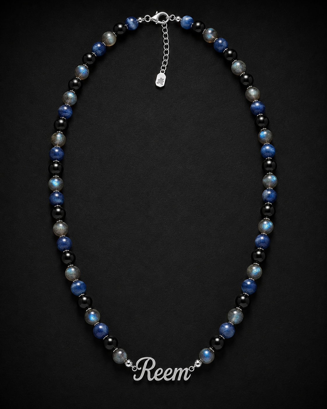 Necklace with blue and black beads on a dark background