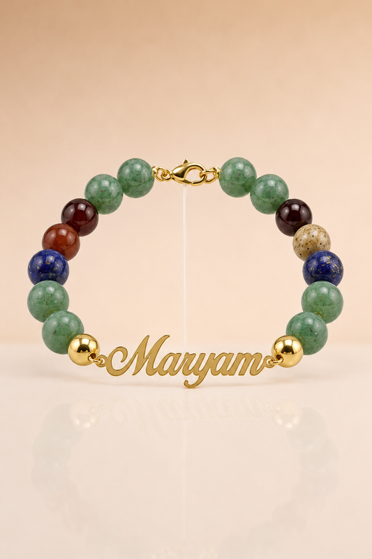 Multicolored beaded bracelet with gold accents on a beige background