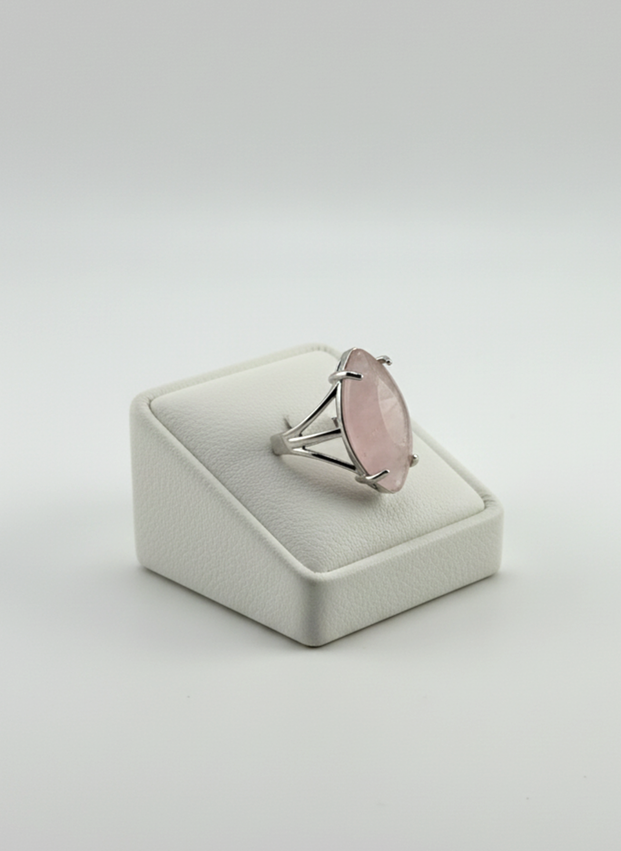 Polished Rose Quartz stone ring displayed on prop