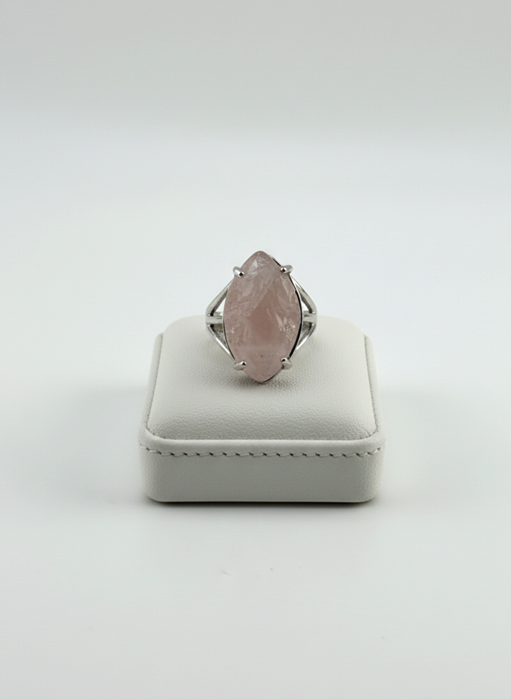 Polished Rose Quartz stone ring displayed on prop