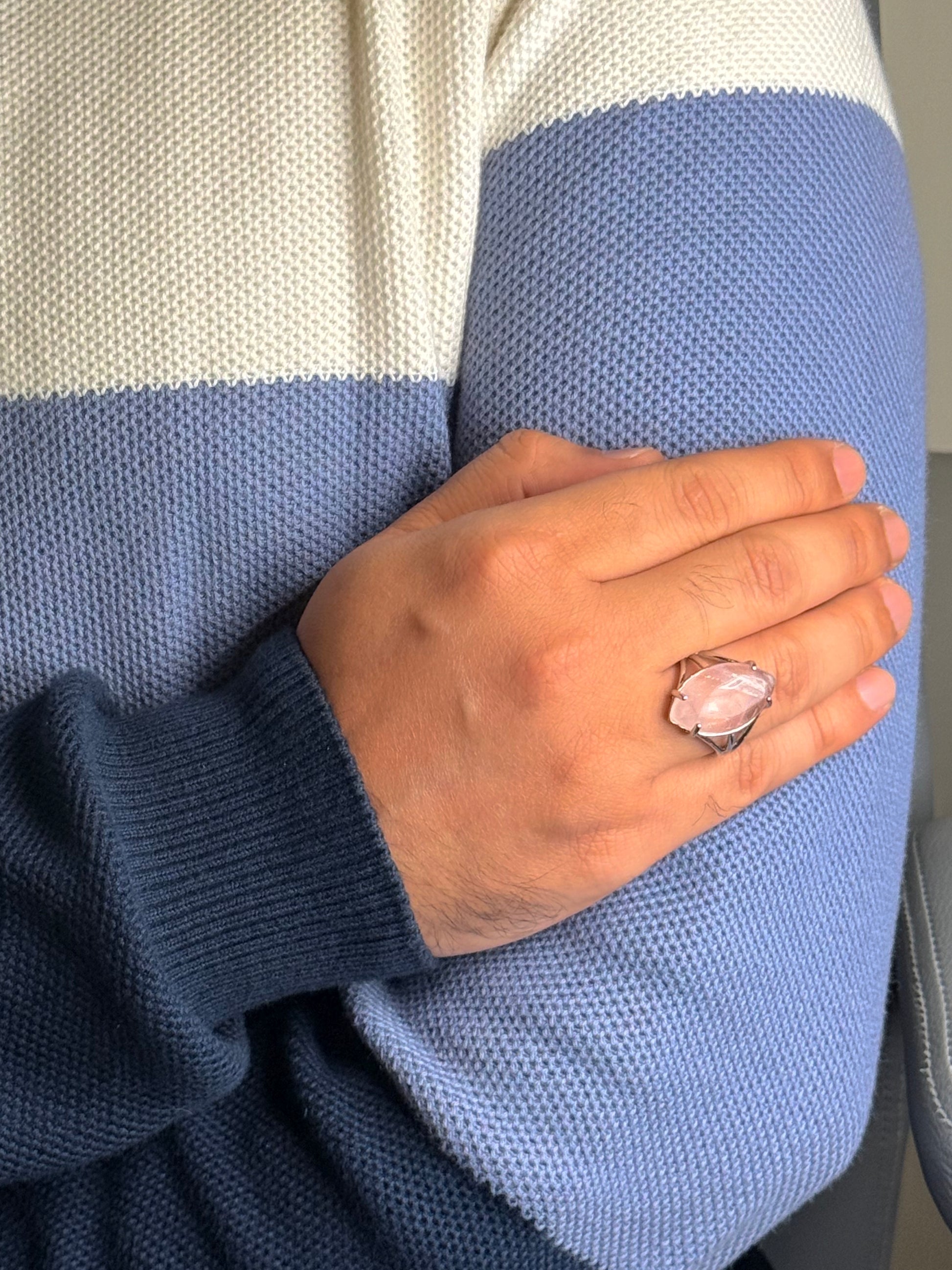 Close up of Rose Quartz gemstone ring on a man’s hand