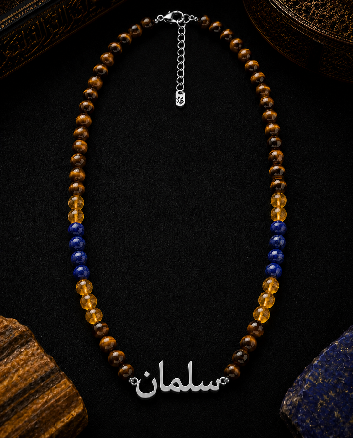 Necklace with brown, yellow, and blue beads on a dark surface