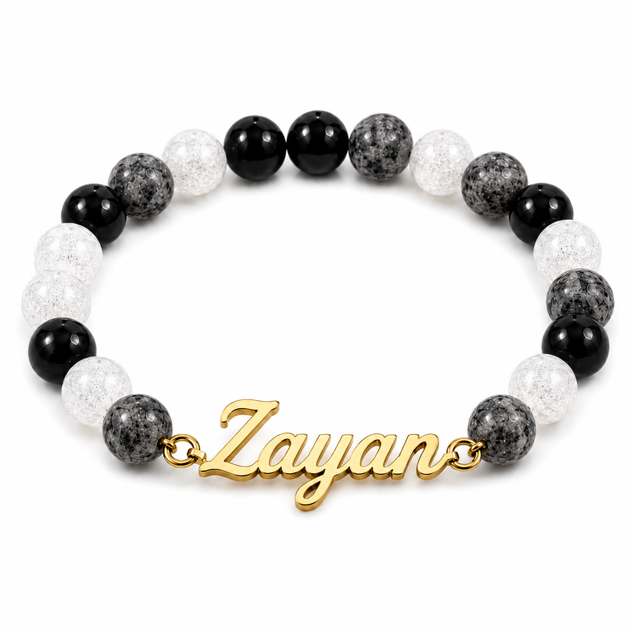 Bracelet with black, white, and gray beads and a gold 'Zayan' charm on a white background