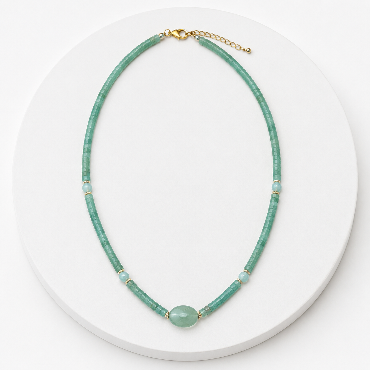 Green beaded necklace on a white plate