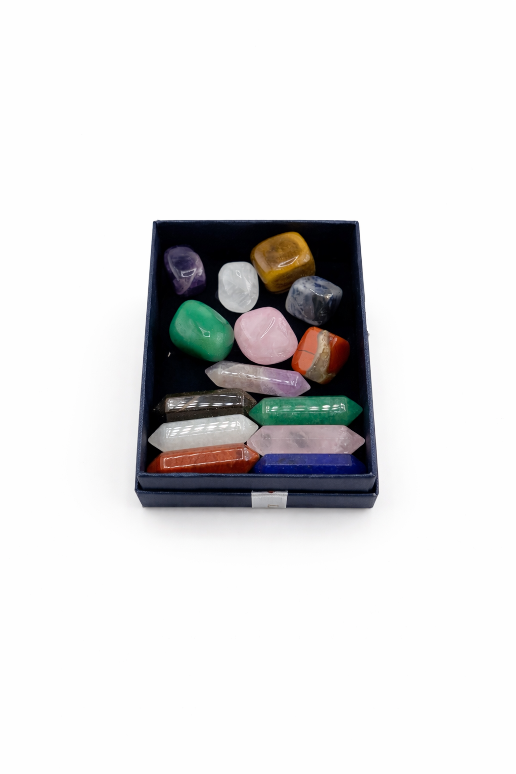 Set of colorful crystals in a black box on a white background