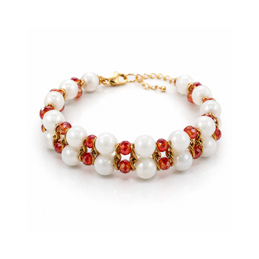 Bracelet with white pearls, red stones, and gold accents on a white background