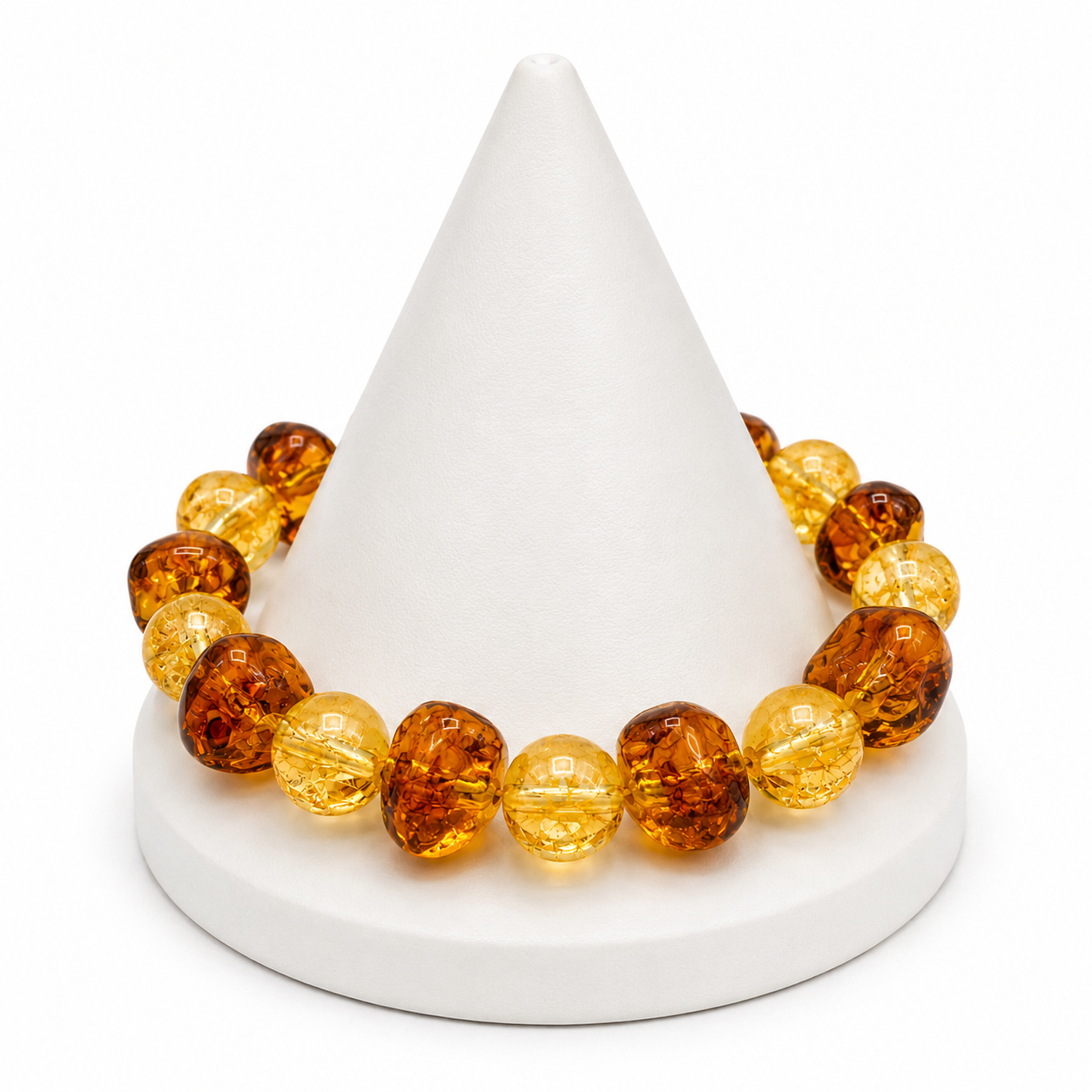 Bracelet with amber-colored beads on a white cone-shaped stand