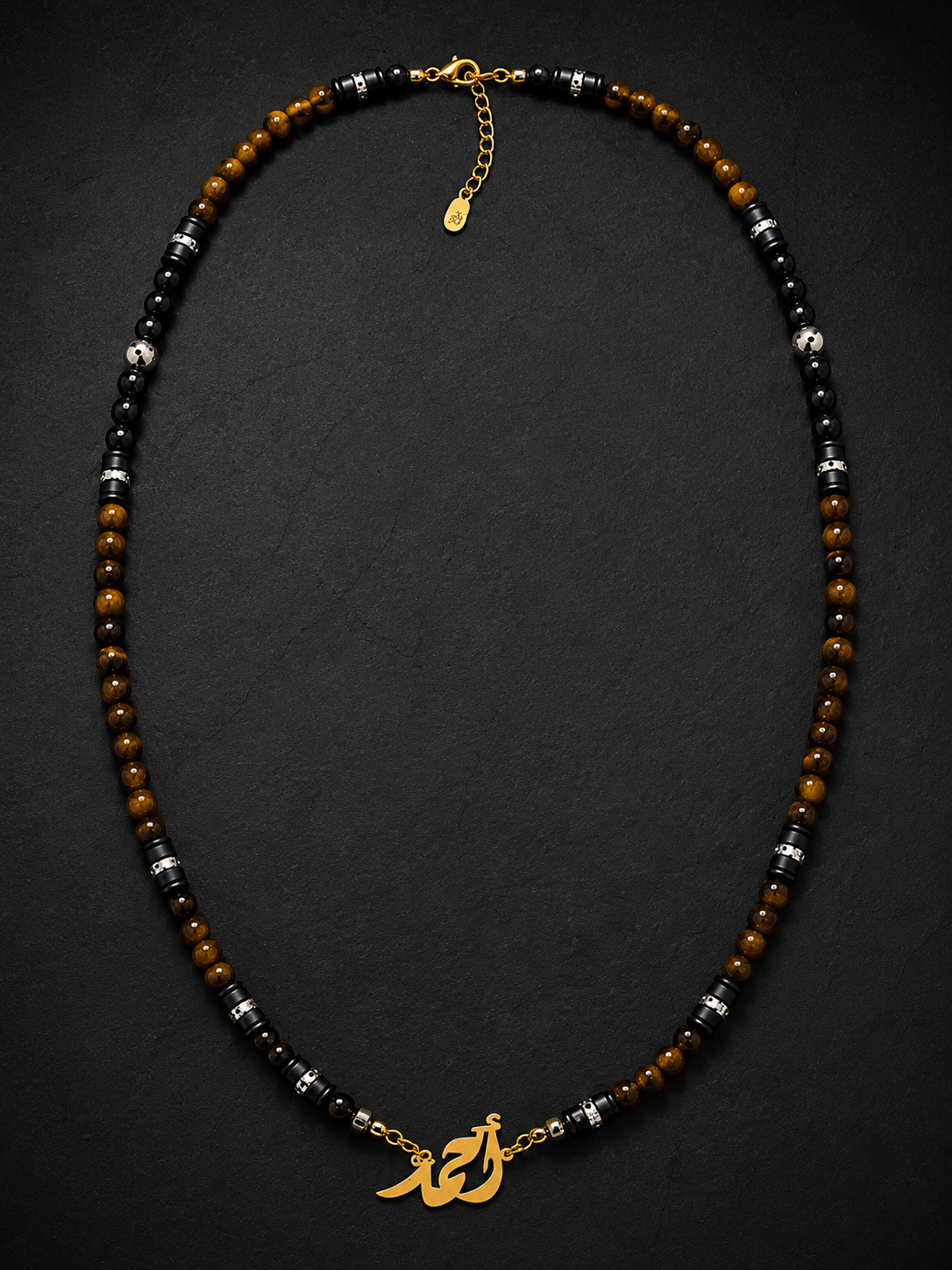 Necklace with beads and gold charm on a dark background